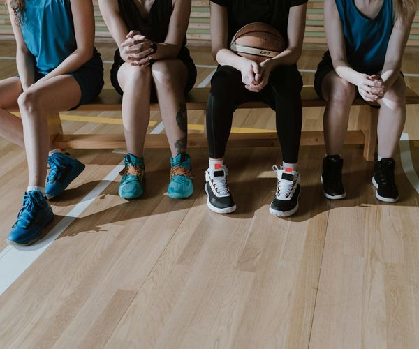A pair of sports shoes on the floor, ready for a workout session.