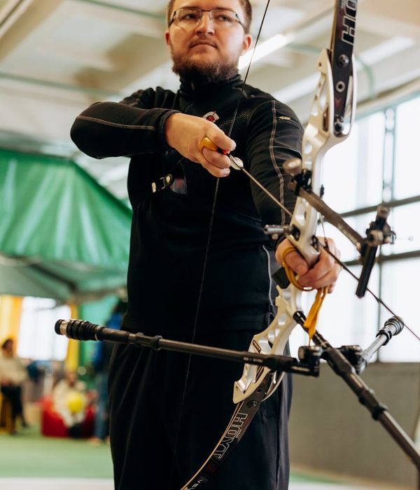 Man performing a controlled strength exercise in a bright, clean space.